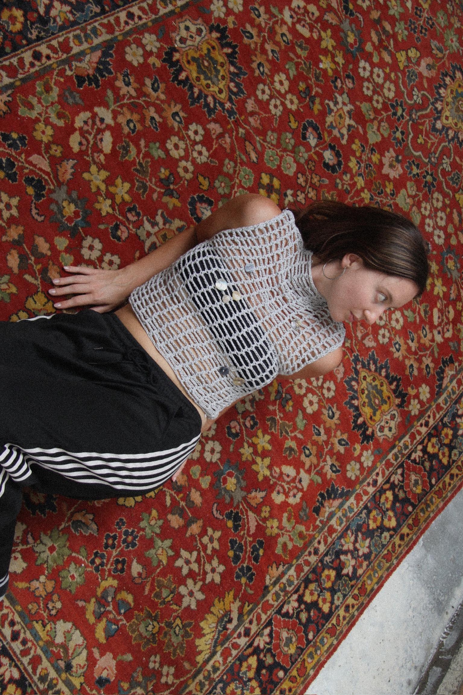 Crochet top on a patterned rug